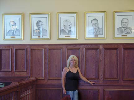 Lorise by some of her governmental portraits in Carteret New Jersey City Hall